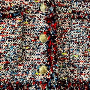 A multi-color tweed jacket with rouche.